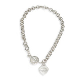 Silver chain bracelet with a heart-shaped tag on a white background