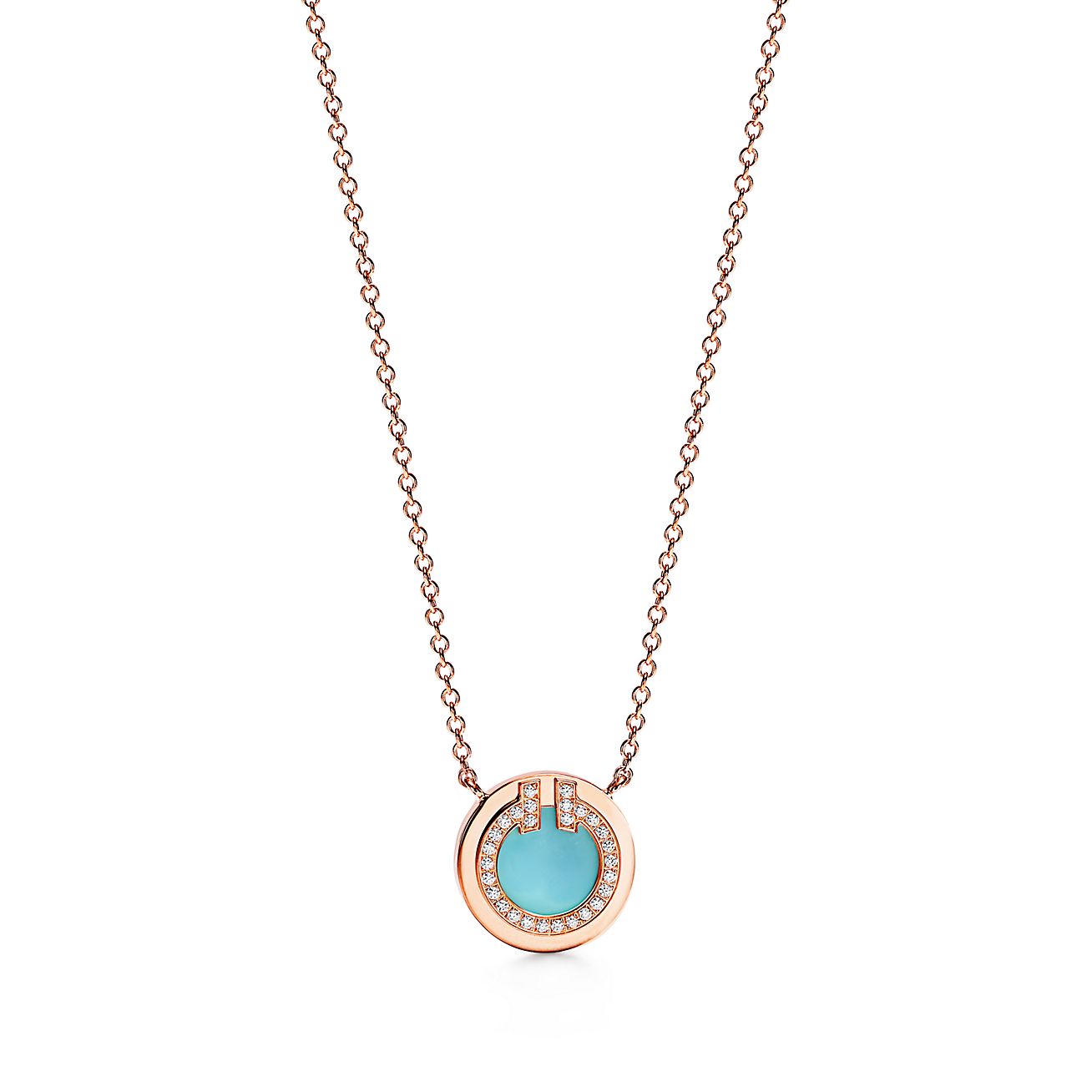 Necklace with a turquoise pendant and rose gold chain on a white background