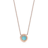 Necklace with a turquoise pendant and rose gold chain on a white background