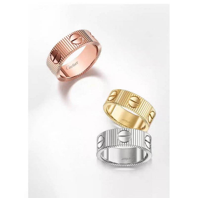 Three gold rings in different colors on a white background