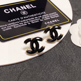 Chanel earrings on a branded card with a gray background